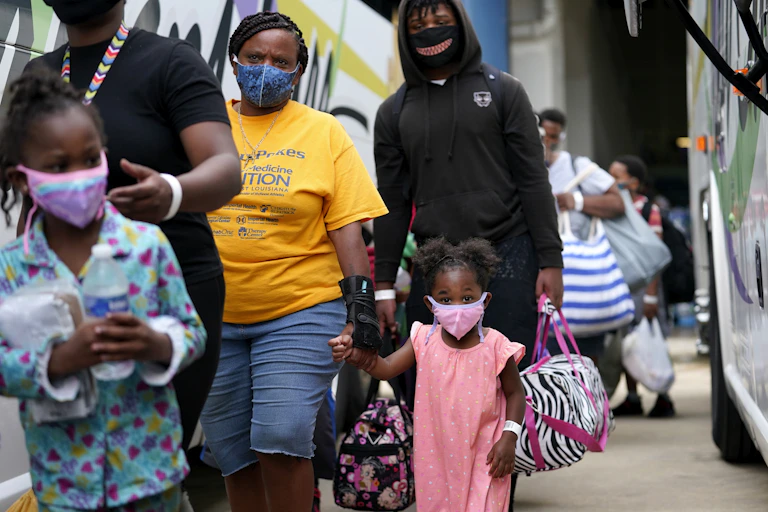 Families being evacuated by bus from Lake Charles, Louisiana, ahead of Hurricane Laura.