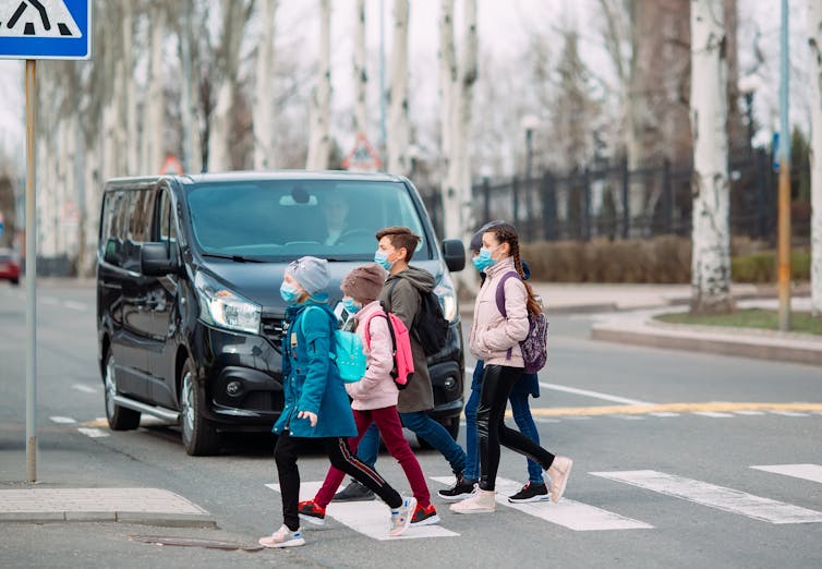 Children walk to school with masks