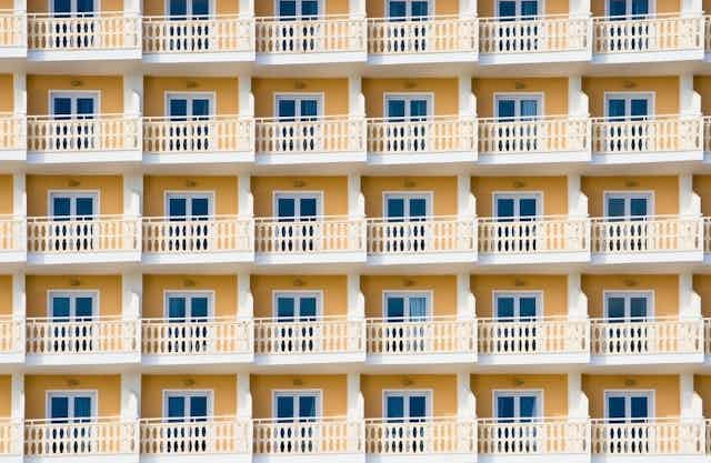 Series of balconies to a yellow hotel building