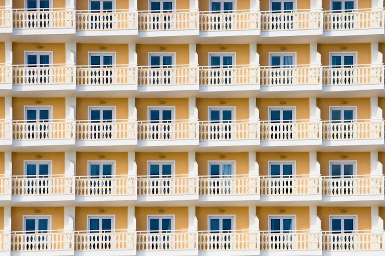Series of balconies to a yellow hotel building