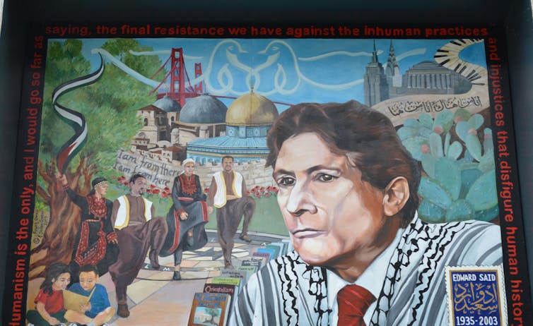 Mural of Edward Said surrounded by people dancing and his books.
