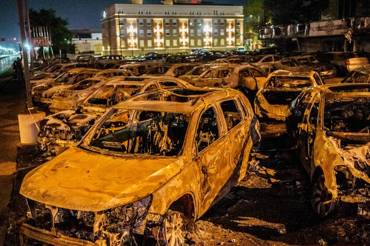 Charred carcasses of used cars burned by protestors