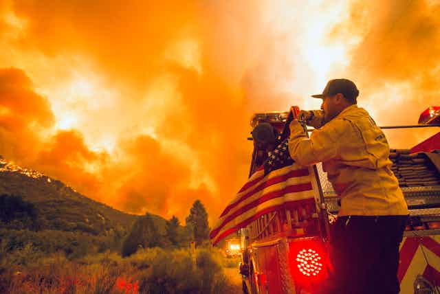 US firefighter watches blaze in California.