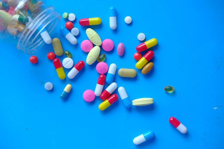 A variety of pills spilling from a bottle