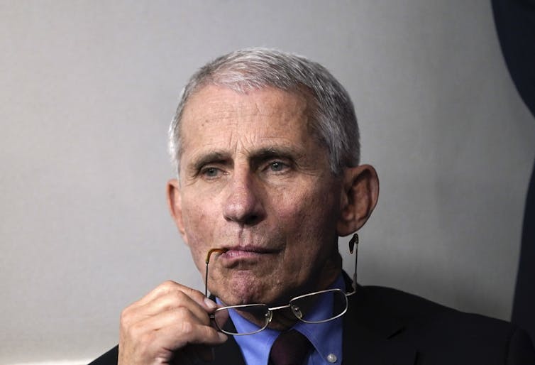Dr. Anthony Fauci sits at the White House.