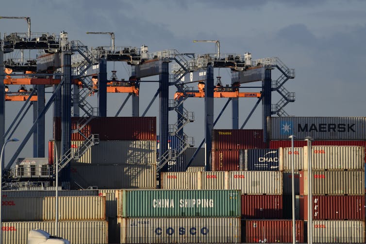 Shipping containers and cranes at a port.