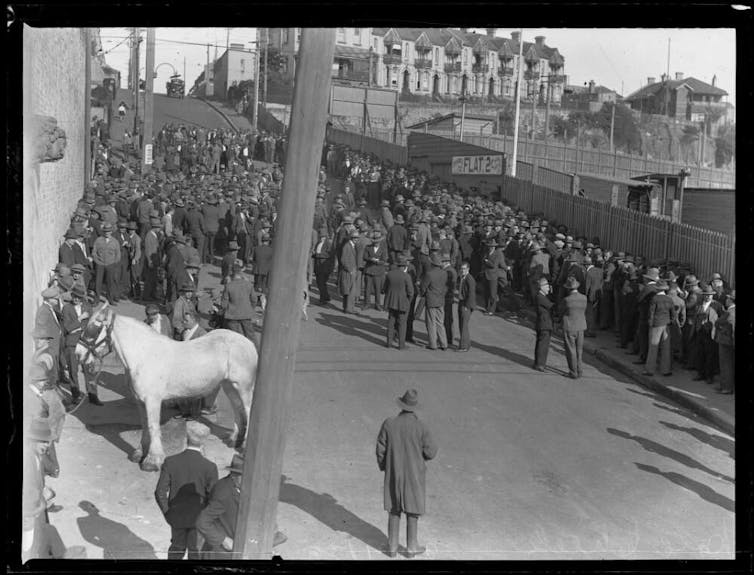 A crowd of men (and a horse)