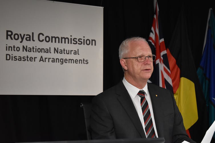 Mark Binskin in front of a sign that says 'Royal Commission into National Natural Disaster Arrangements'