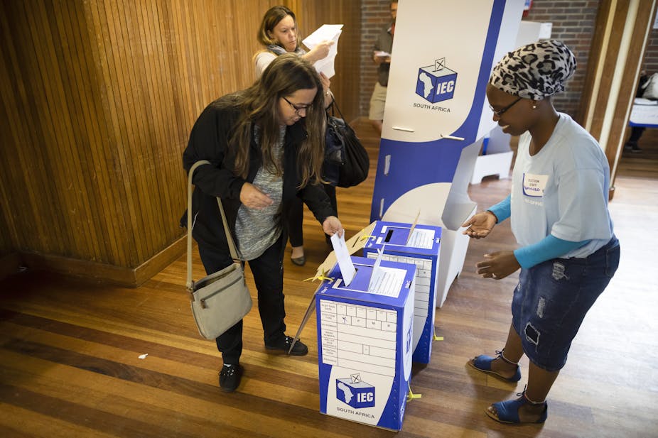 A woman puts her ballot paper in a ballot box during recent elections in South Africa