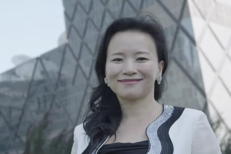 Detained CGTN achor Cheng Lei in front of a Beijing skyline.
