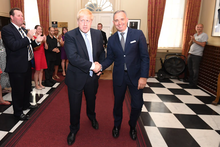 Boris Johnson shakes hands with his top civil servant.
