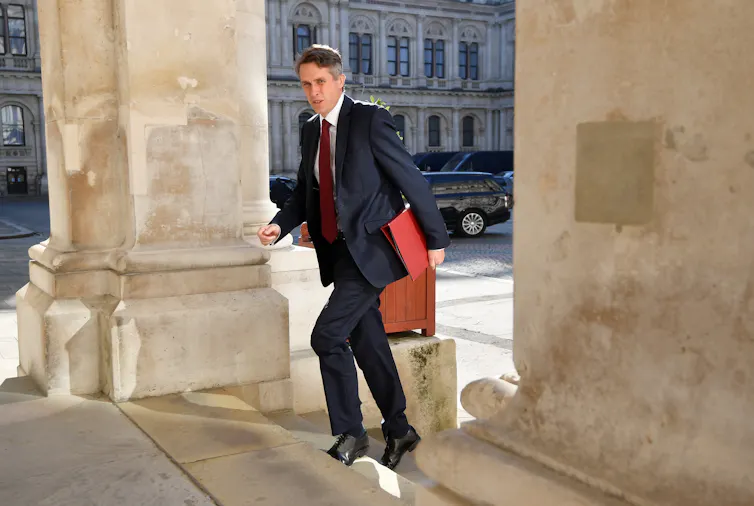 Education minister Gavin Williamson enter a government building.