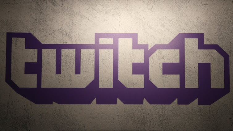 The purple logo of Twitch on a wall.
