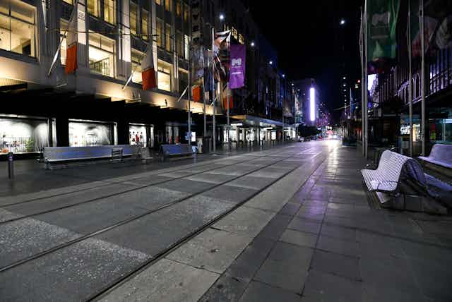 View of deserted Bourke Street Mall in Melbourne under nighttime COVID-19 curfew