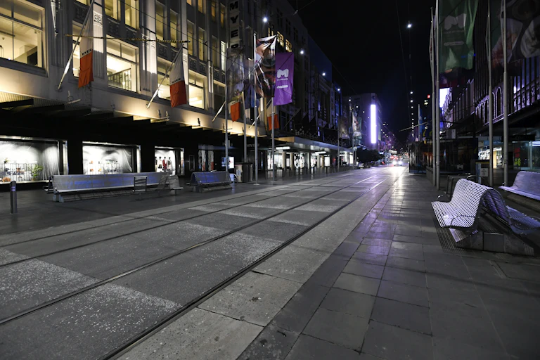 View of deserted Bourke Street Mall in Melbourne under nighttime COVID-19 curfew