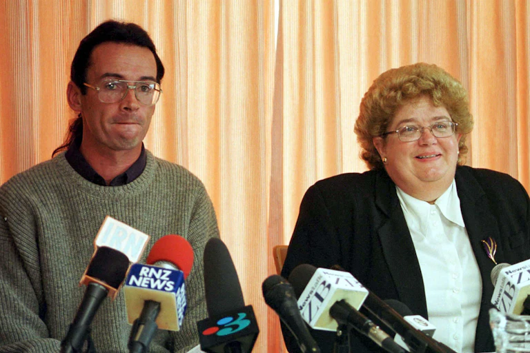 Man and woman lawyer with media microphones