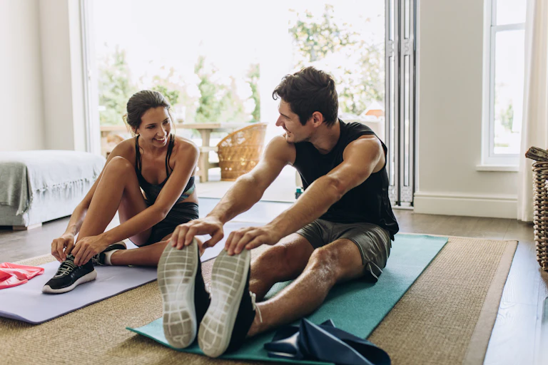 Young couple stretch after a workout.