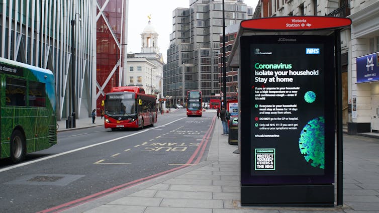 A sign on a London street tells people to stay at home during the pandemic.