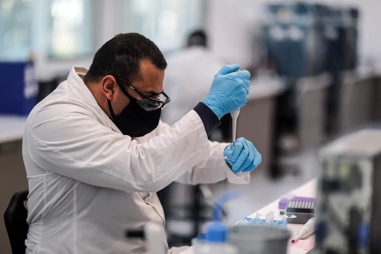 A researcher using a pipette