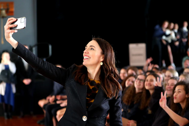 Jacinda Ardern taking selfie with shoolchildren