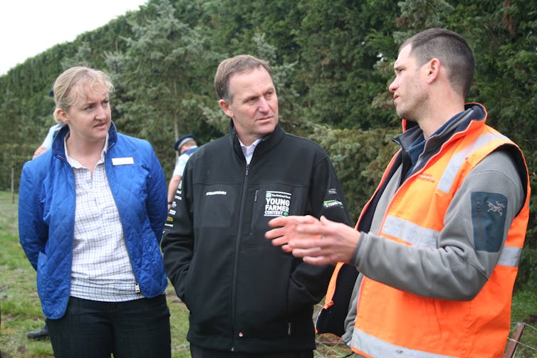 Three people in discussion.