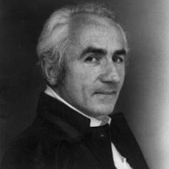 Middle-aged man in evening dresss photographed in profile.
