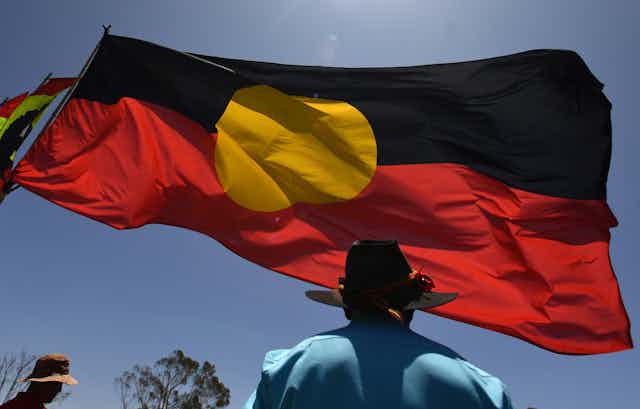 Aboriginal flag flying against blue sky