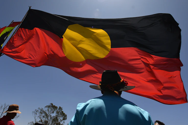Aboriginal flag flying against blue sky