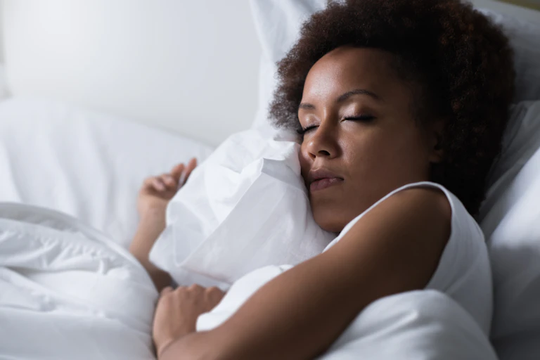 Woman sleeping in bed.