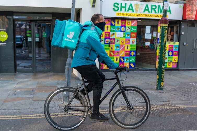 Deliveroo worker cycles down empty high street