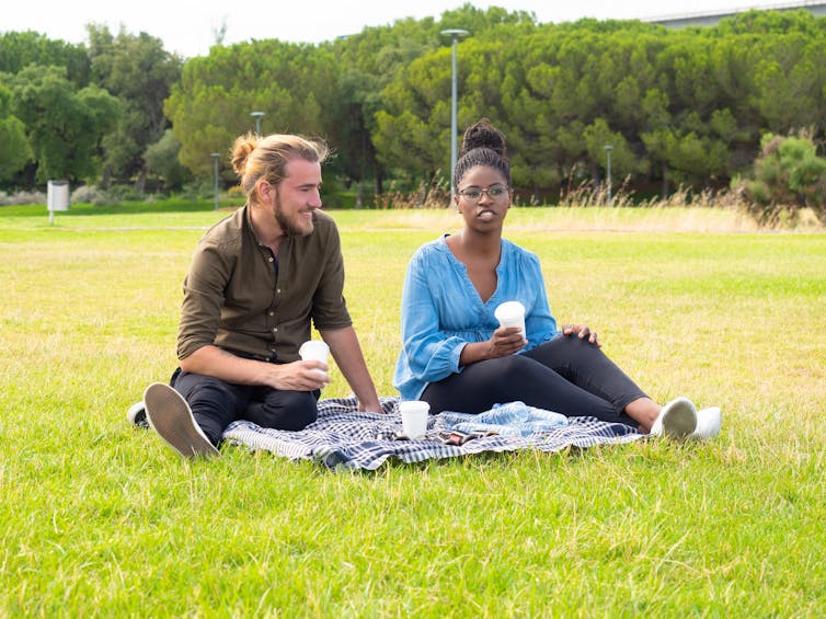 Two people sitting in the park