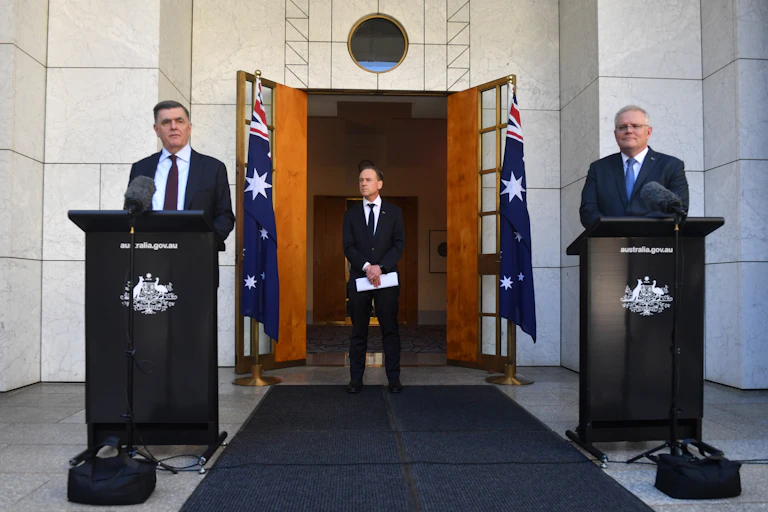 Brendan Murphy, Greg Hunt, and Scott Morrison, at a press conference