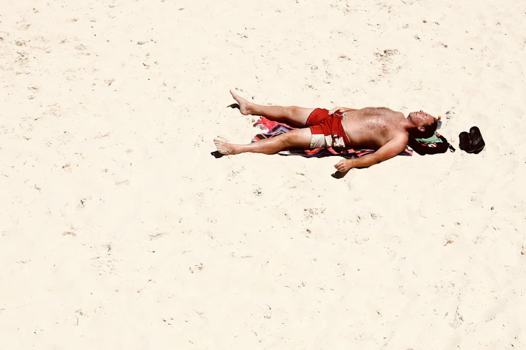 Man sunbathes on beach