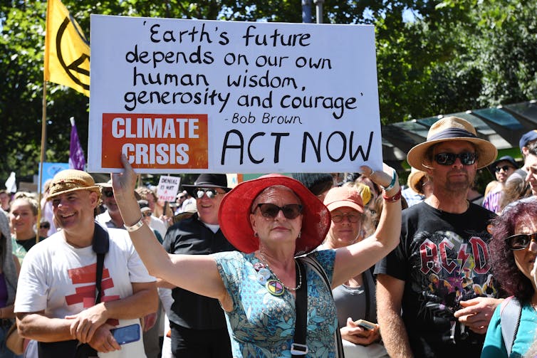 Woman holds a sign at a climate protest