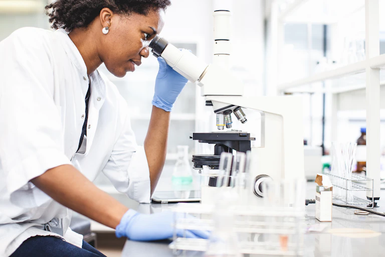 Scientist Looking into the Microscope