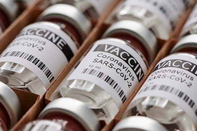 Vials marked 'VACCINE Coronavirus' in a box.