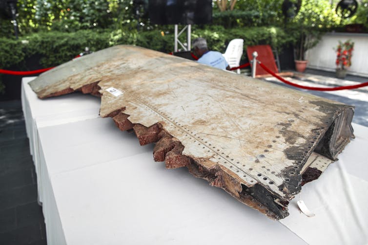 A piece of debris from missing flight MH370 displayed.