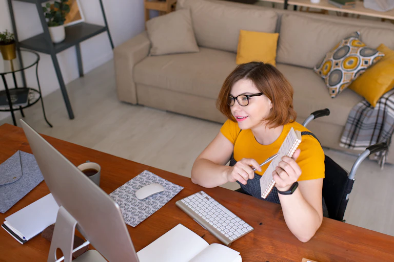 Student looking at desktop screen as she talks with teacher in an online learning session