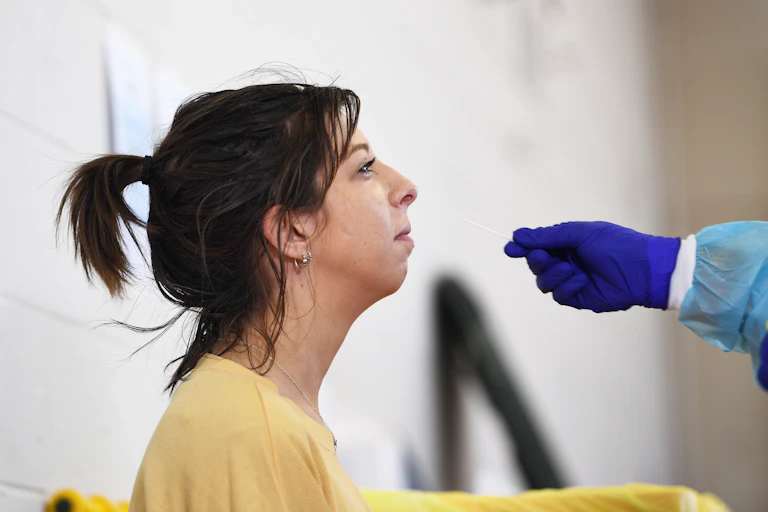 A young woman having a COVID test.
