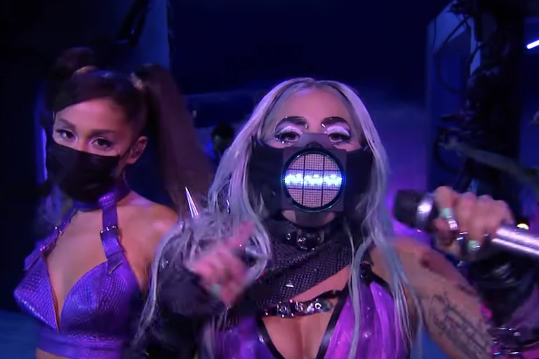 Lady Gaga in a facemask with a sound wave and Arianna Grande in a black face mask.