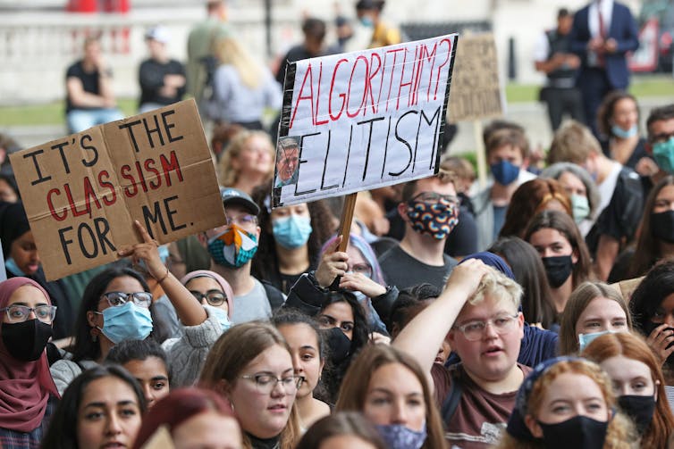 Group of students protesting and holding signs.