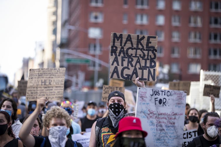 A march with white and Black protesters.