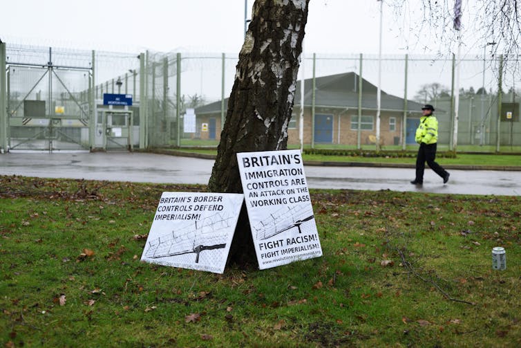 Protest placards outside immigration detention centre.