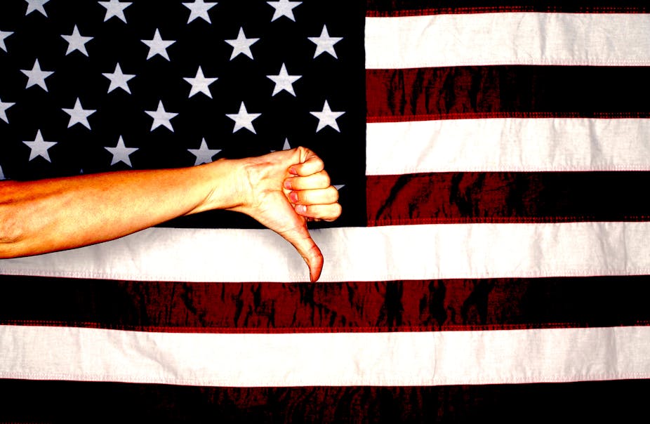 American flag with hand making a thumbs down