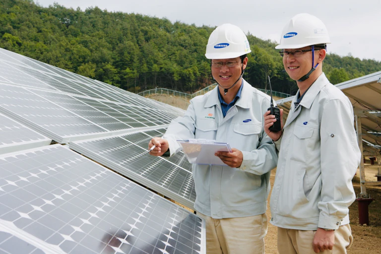 Two men inspect a sollar array