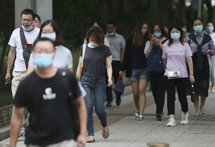 People in
South Korea walk wearing face masks