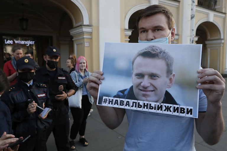 Man holding poster of Alexei Navalny.