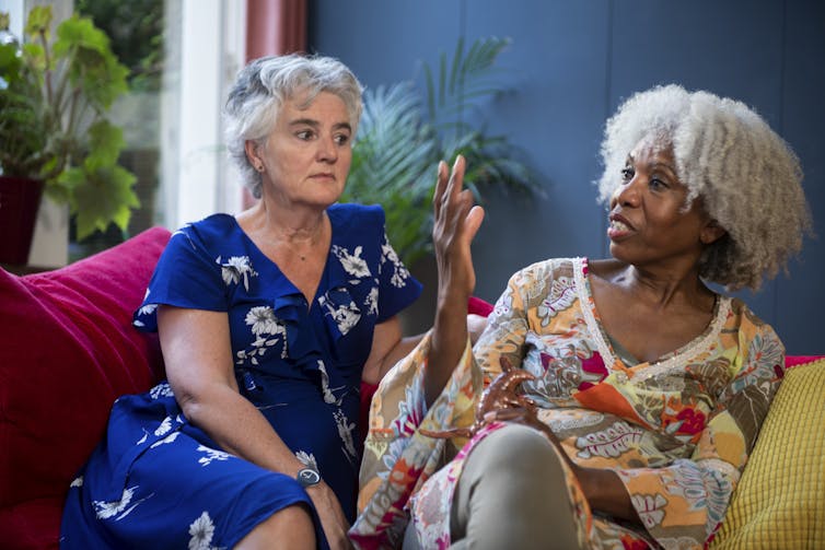 Two women holding a serious conversation.