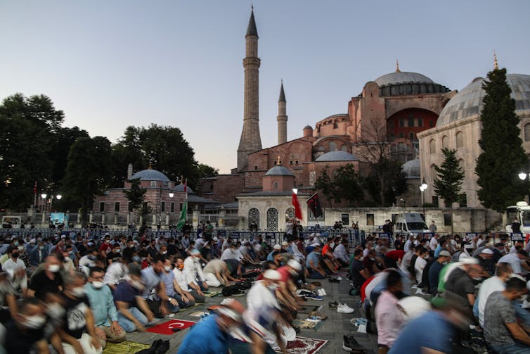 Many people pray in front of Hagia Sofia.