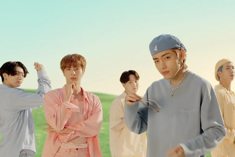The seven members of BTS in a field